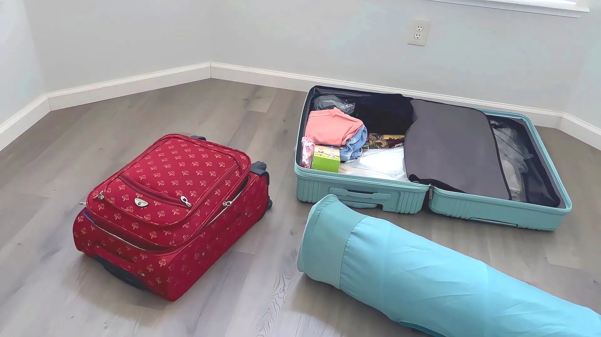 Two suitcases packed and ready on the floor for a trip to Taiwan